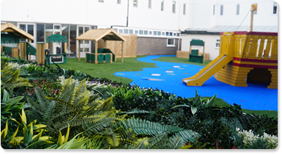 Outdoor playground equipment with vibrant artificial grass