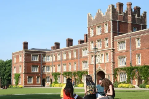 university of cambridge virtual tour on grass with people in front of college